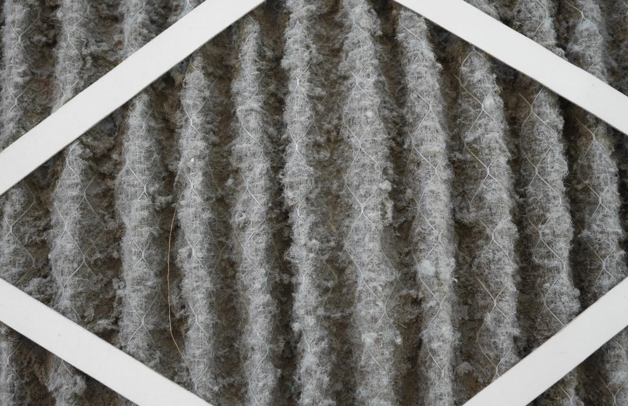 Dirty HVAC air filter restricting airflow and reducing AC cooling performance