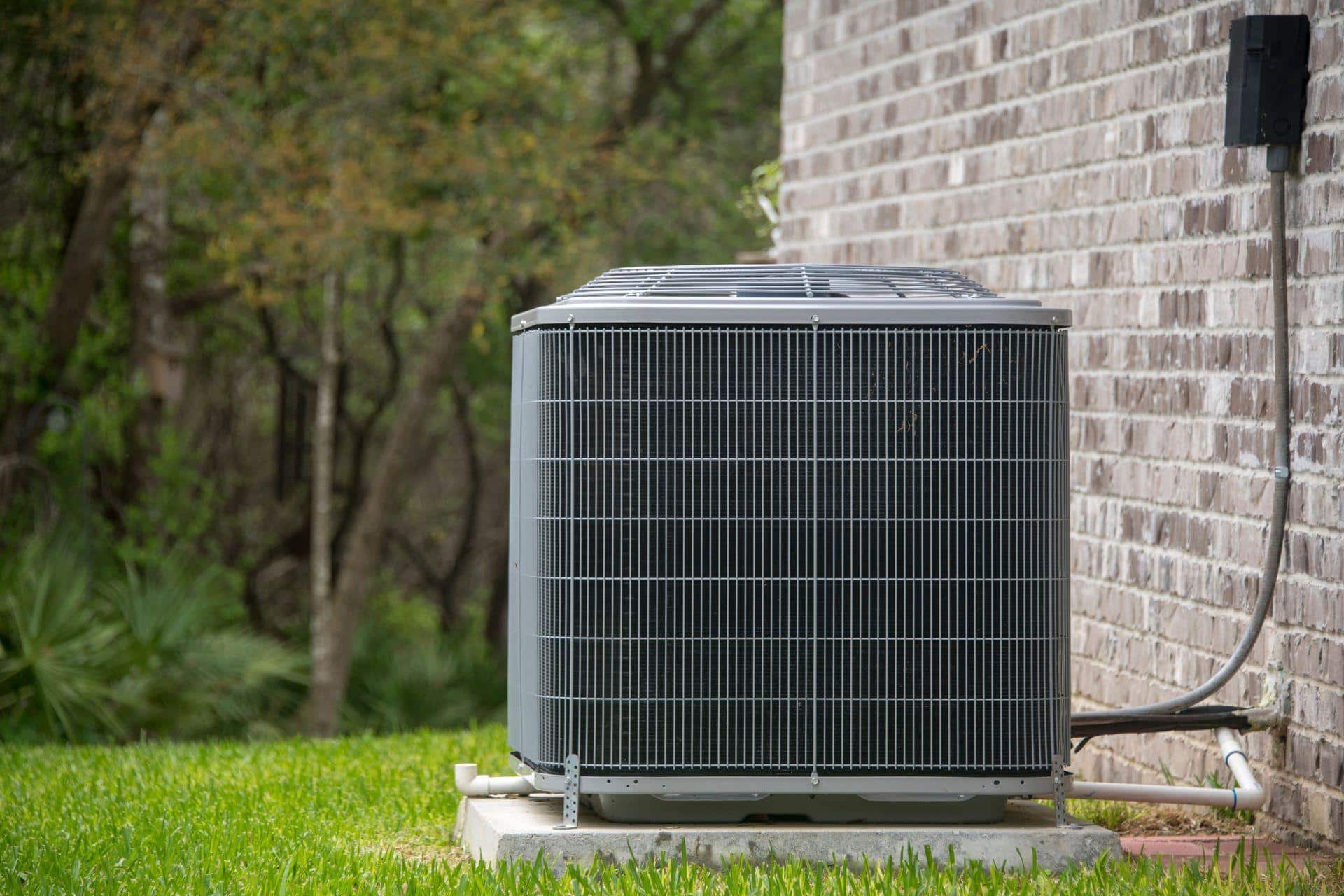 Outdoor AC condenser unit checked for cooling and airflow problems